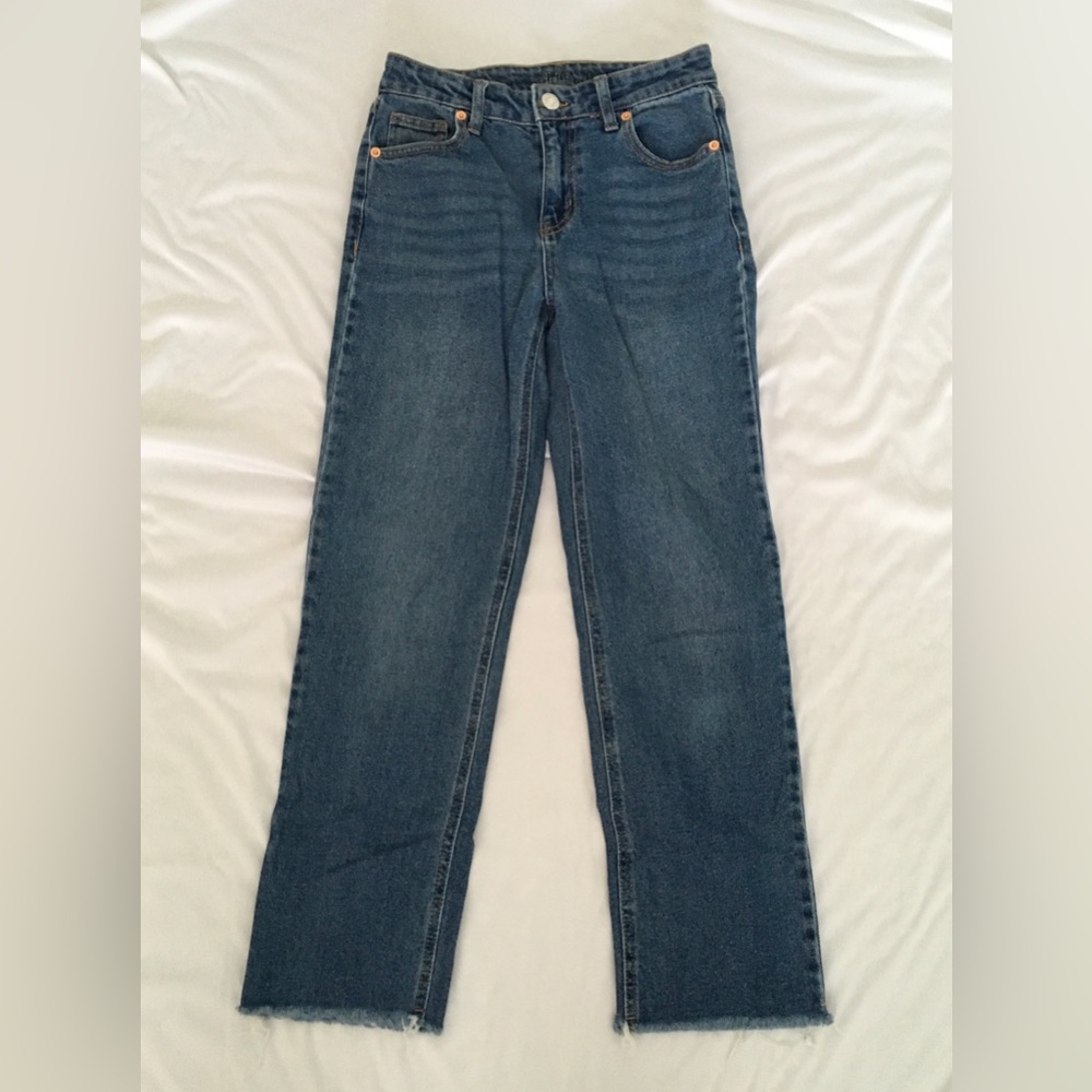 Blue straight leg jeans with a relaxed fit and frayed bottoms